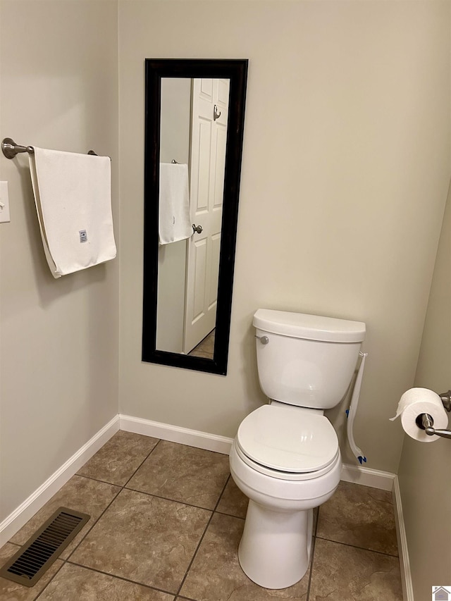 bathroom featuring tile patterned flooring and toilet