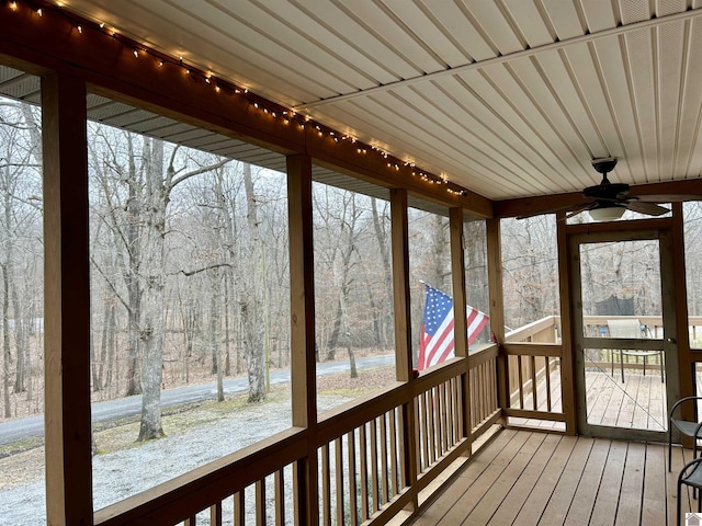 unfurnished sunroom featuring track lighting