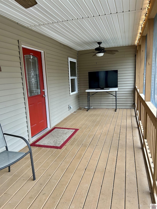 wooden deck featuring ceiling fan