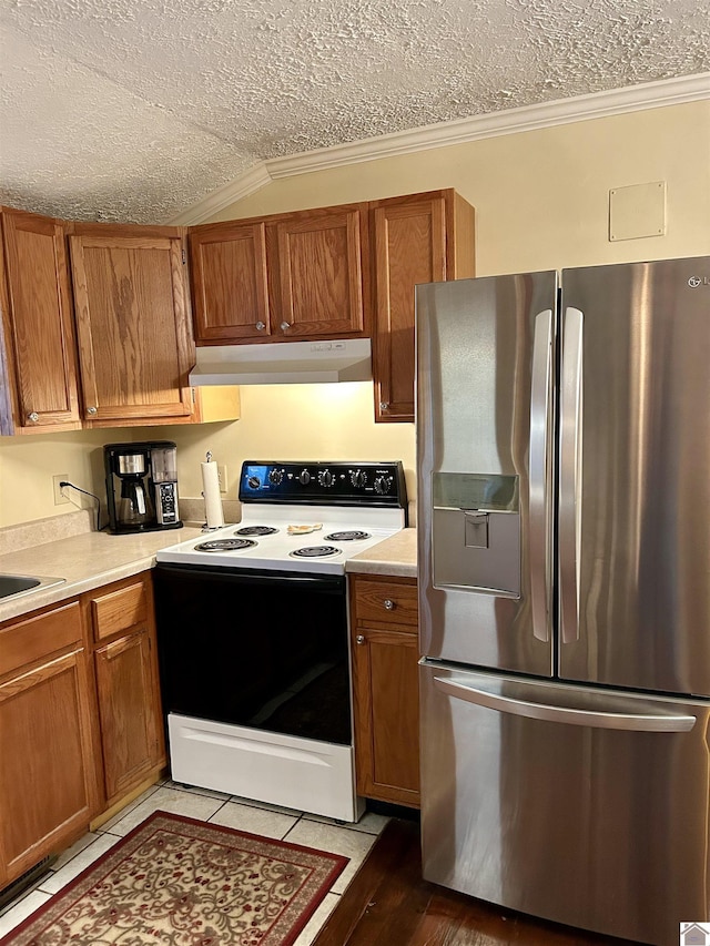 kitchen with range with electric stovetop, stainless steel refrigerator with ice dispenser, ornamental molding, and a textured ceiling