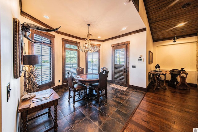 dining area featuring a notable chandelier, ornamental molding, and dark hardwood / wood-style floors