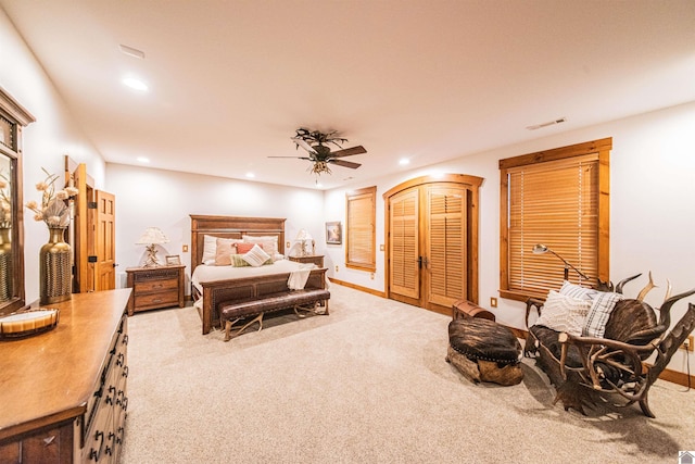 bedroom featuring light carpet and ceiling fan