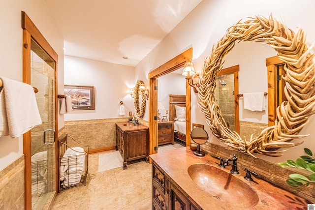 bathroom featuring vanity and a shower with shower door