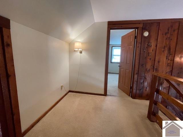 additional living space with lofted ceiling and light carpet