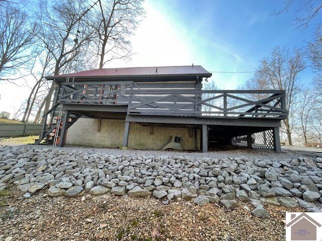 back of property featuring a deck