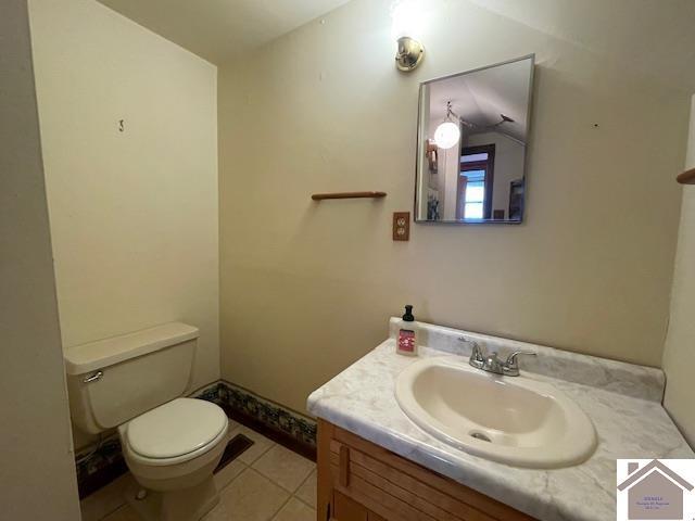 bathroom with tile patterned flooring, vanity, and toilet