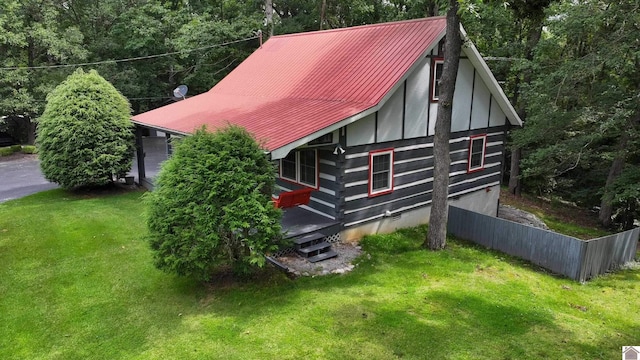 view of side of home featuring a lawn