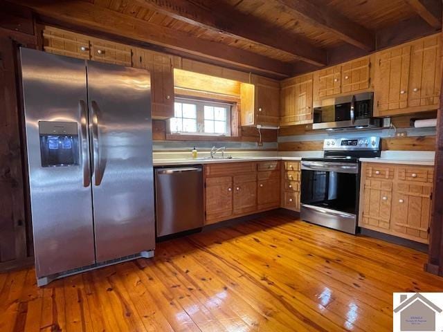 kitchen with sink, beam ceiling, wood ceiling, stainless steel appliances, and light wood-type flooring