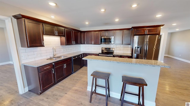 2206 Traci Dr, Murray, KY 42071 - kitchen featuring baseboards, a sink, a kitchen bar, and appliances with stainless steel finishes