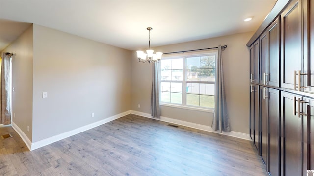 2206 Traci Dr, Murray, KY 42071 - unfurnished dining area with recessed lighting, baseboards, a notable chandelier, and light wood-style flooring