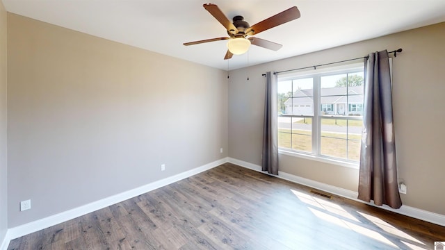2206 Traci Dr, Murray, KY 42071 - unfurnished room with baseboards, wood finished floors, visible vents, and ceiling fan