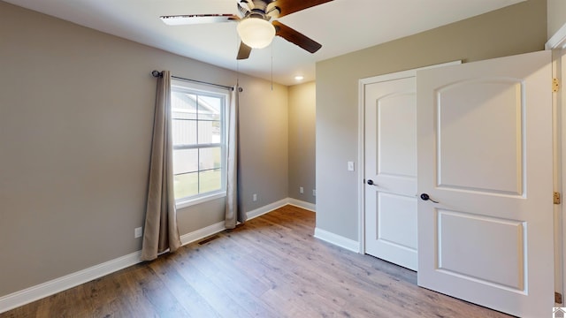 2206 Traci Dr, Murray, KY 42071 - unfurnished bedroom featuring visible vents, light wood finished floors, baseboards, and a ceiling fan