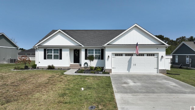 view of front of home with a garage and a front lawn