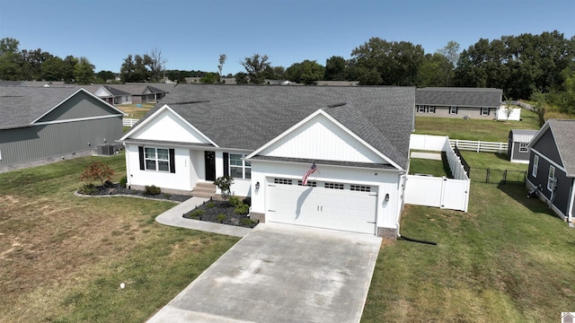 2206 Traci Dr, Murray, KY 42071 - view of front of home with fence, a shingled roof, driveway, a front yard, and a garage