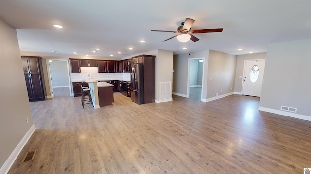 2206 Traci Dr, Murray, KY 42071 - kitchen featuring a kitchen breakfast bar, open floor plan, visible vents, freestanding refrigerator, and ceiling fan