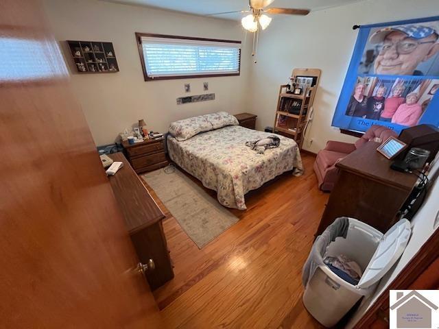 bedroom with light hardwood / wood-style flooring and ceiling fan