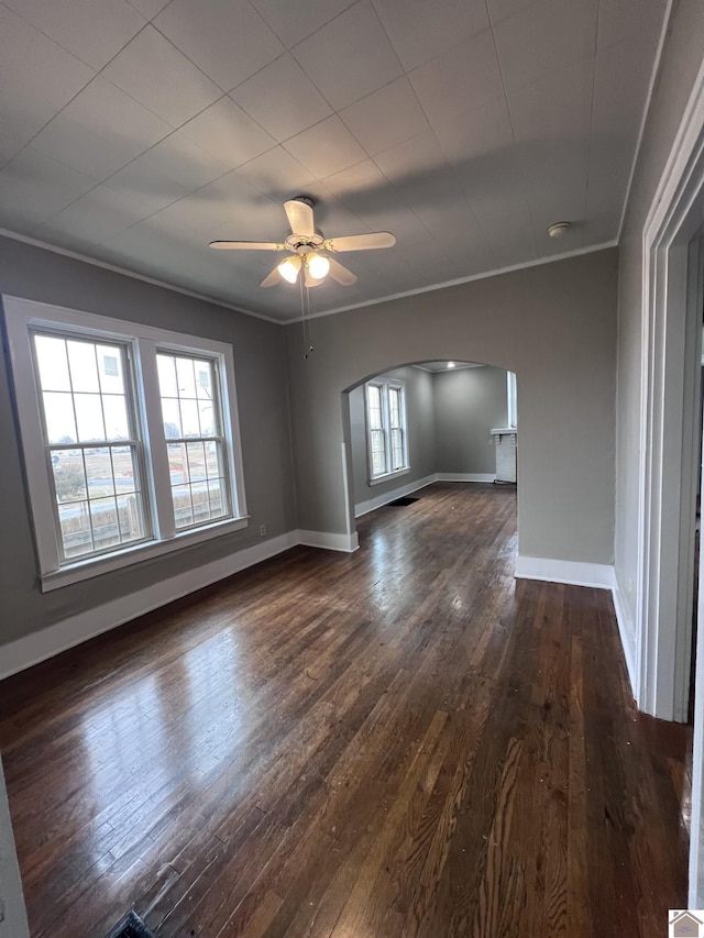 spare room featuring ceiling fan, ornamental molding, and dark hardwood / wood-style floors