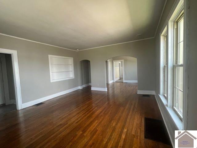 unfurnished room featuring crown molding and dark hardwood / wood-style floors