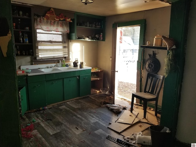 kitchen with sink, dark hardwood / wood-style floors, and green cabinetry