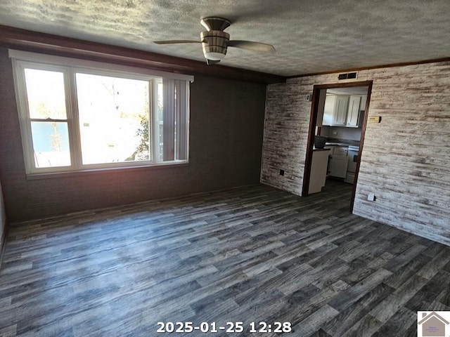 unfurnished bedroom with ceiling fan, dark hardwood / wood-style flooring, and a textured ceiling