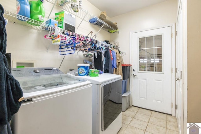 clothes washing area featuring light tile patterned flooring and independent washer and dryer