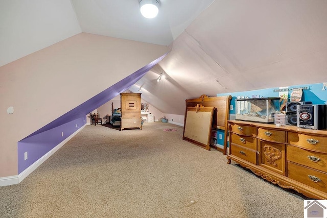 interior space featuring carpet floors and vaulted ceiling