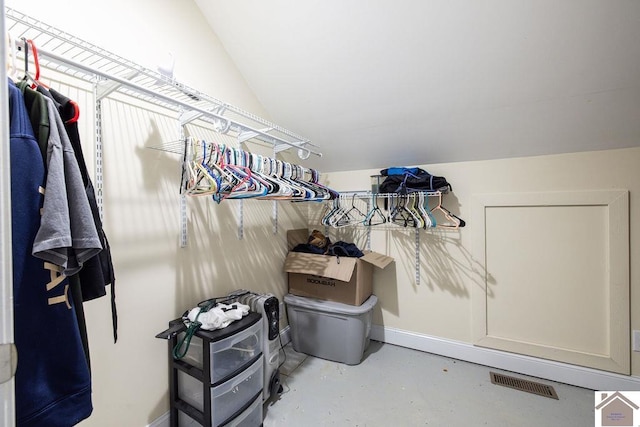 walk in closet featuring lofted ceiling