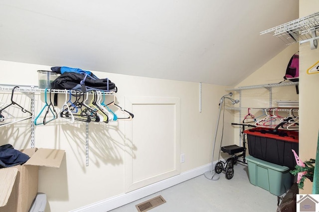 walk in closet featuring vaulted ceiling