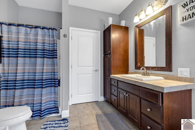 bathroom with vanity, walk in shower, tile patterned floors, and toilet