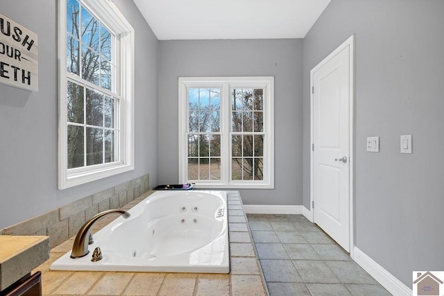 bathroom with tile patterned flooring and a relaxing tiled tub