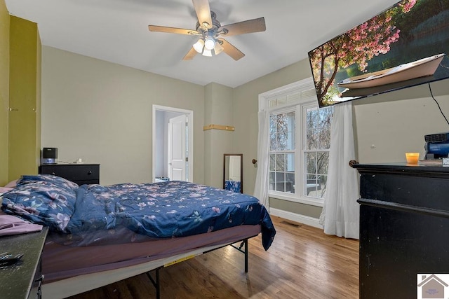 bedroom with hardwood / wood-style flooring and ceiling fan