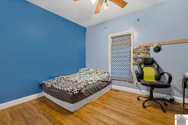 bedroom with hardwood / wood-style flooring and ceiling fan