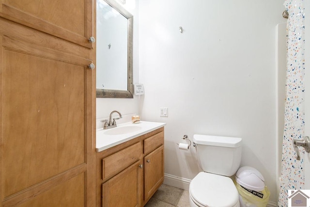 bathroom featuring tile patterned floors, vanity, toilet, and curtained shower