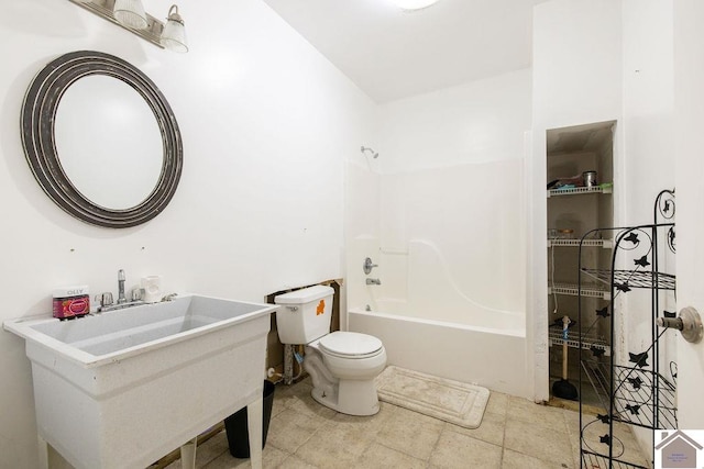 full bathroom with sink, bathtub / shower combination, and toilet