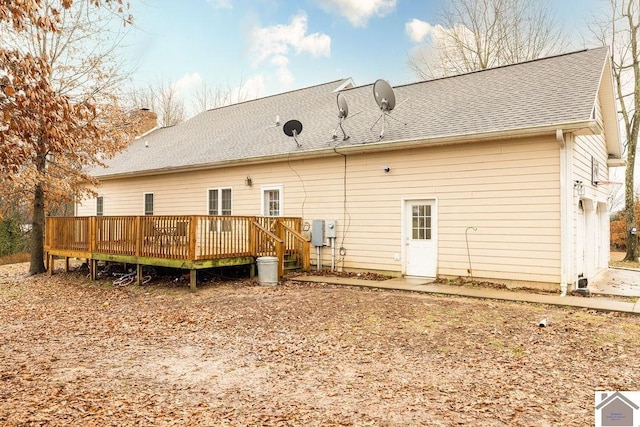 rear view of house featuring a wooden deck