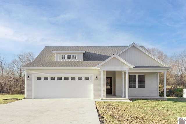 view of front facade featuring a garage, a porch, and a front yard