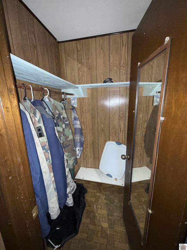 spacious closet featuring dark parquet floors