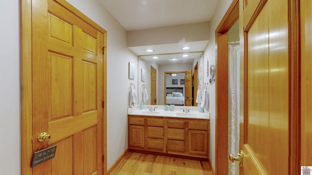 bathroom with hardwood / wood-style flooring and vanity