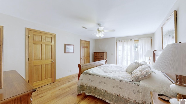 bedroom with light hardwood / wood-style flooring and ceiling fan