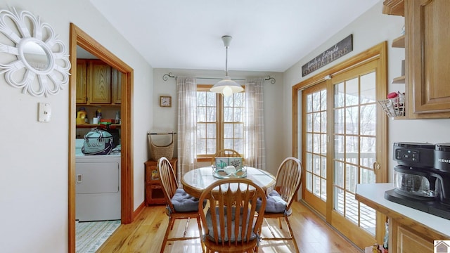 dining area with washer / clothes dryer and light hardwood / wood-style floors