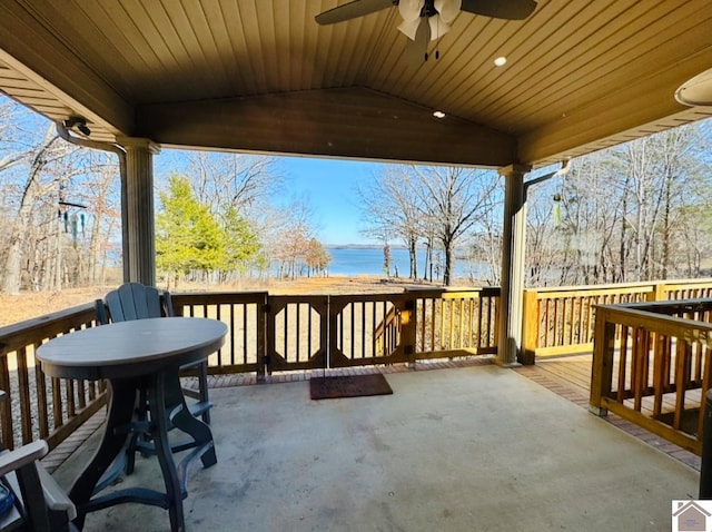 view of patio with a water view and ceiling fan