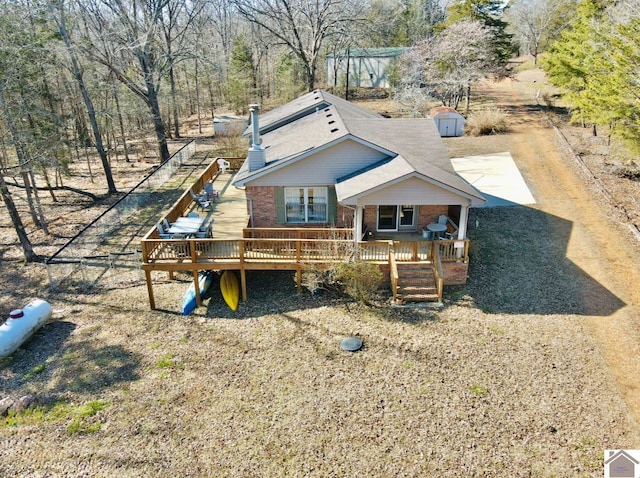 exterior space featuring a storage shed and a deck