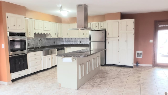 kitchen featuring sink, a kitchen island, island exhaust hood, stainless steel appliances, and backsplash