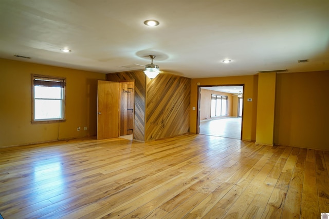 unfurnished room with ceiling fan and light wood-type flooring