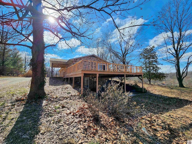 back of house with a wooden deck