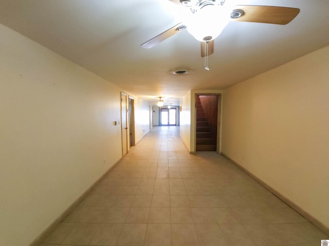 corridor featuring light tile patterned flooring