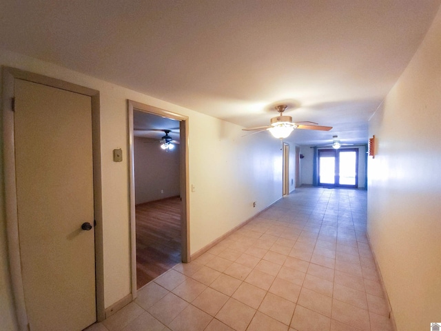 hall featuring light tile patterned flooring