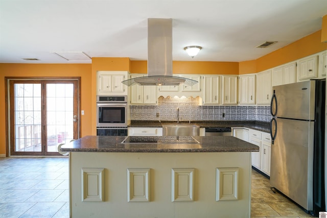 kitchen featuring sink, appliances with stainless steel finishes, backsplash, a center island, and island range hood