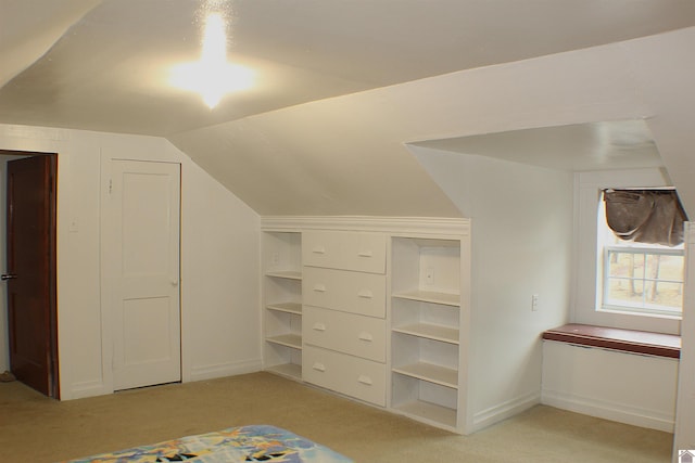 additional living space featuring vaulted ceiling and light carpet