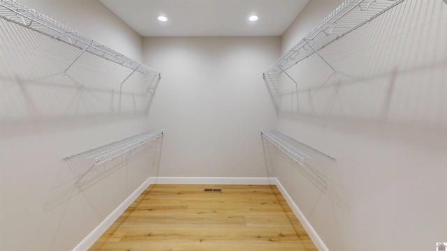 walk in closet featuring hardwood / wood-style floors